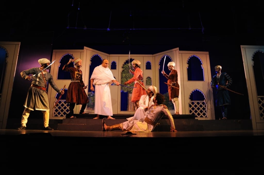 The full ensemble of Bhamasha on stage at NCPA — battle scene with Mughal-era sets